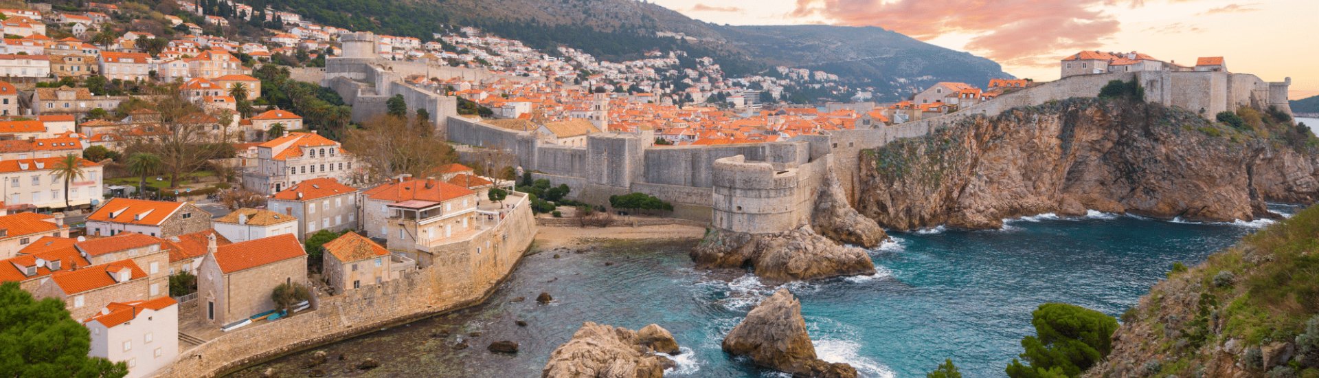 sunset view of dubrovnik castle and bay