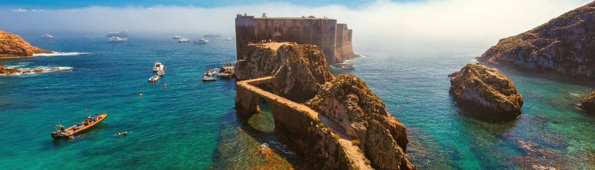 portugal castle ruins in the middle of the sea with crystal clear waters