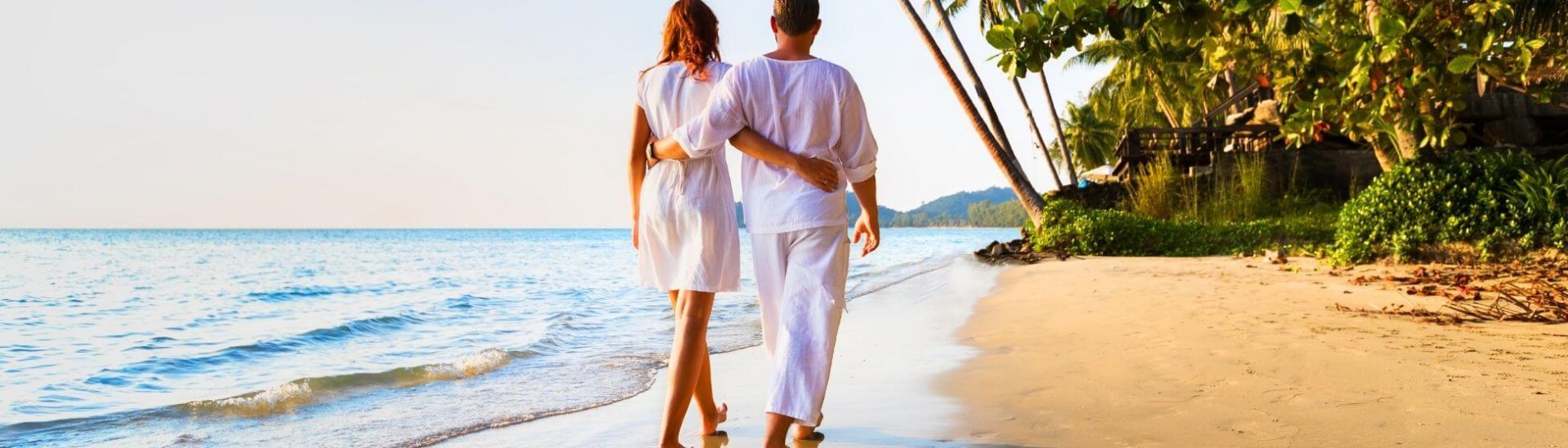 honeymoon couple enjoying a stroll on a caribbean beach